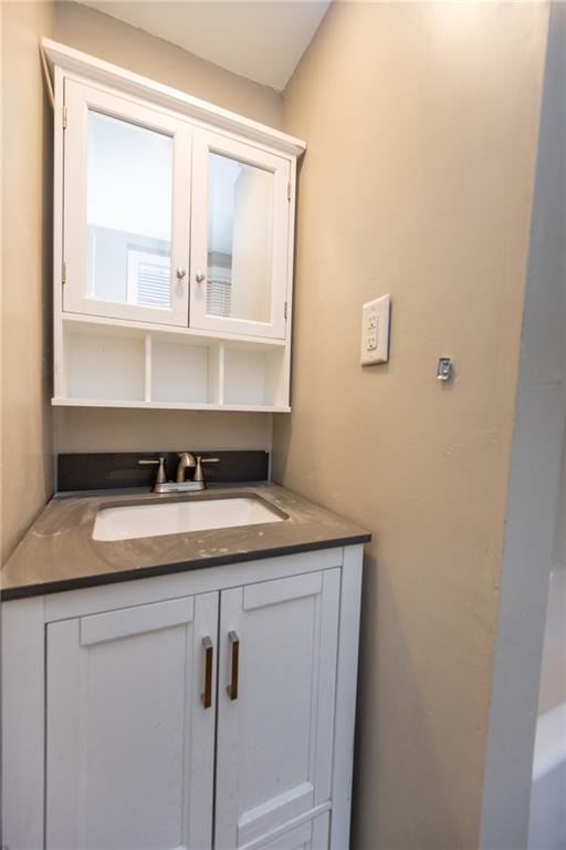 105 Washington Street Mount Pleasant, PA 15666 - Photo 21 of 29 a bathroom with a granite countertop sink and a mirror