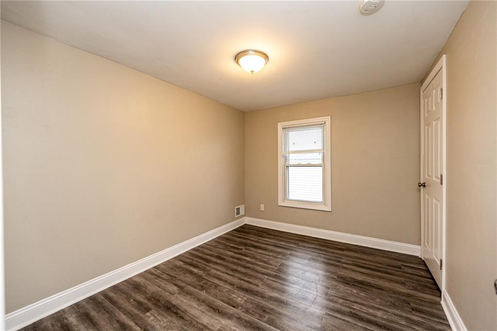 105 Washington Street Mount Pleasant, PA 15666 - Photo 25 of 29 a view of an empty room with wooden floor and a window