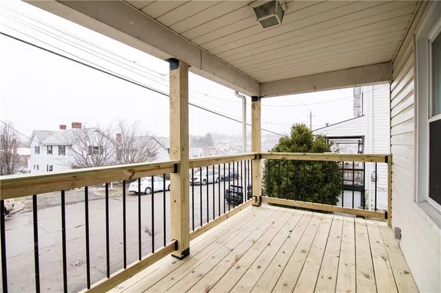 a view of a balcony with wooden floor