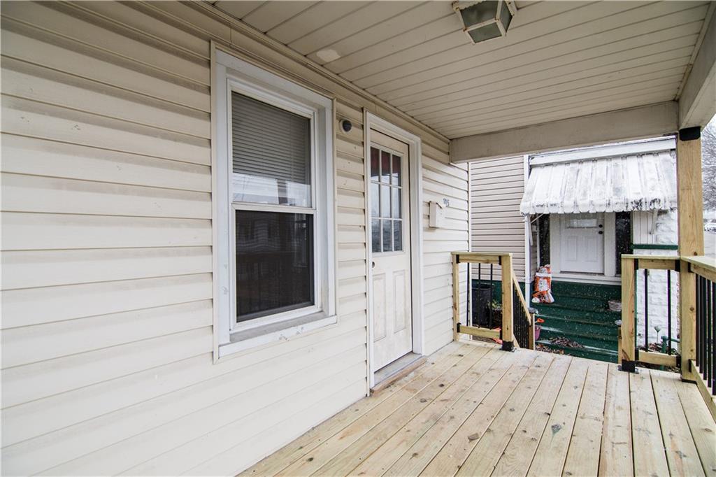 105 Washington Street Mount Pleasant, PA 15666 - Photo 7 of 29 a view of a livingroom with wooden floor and a ceiling fan