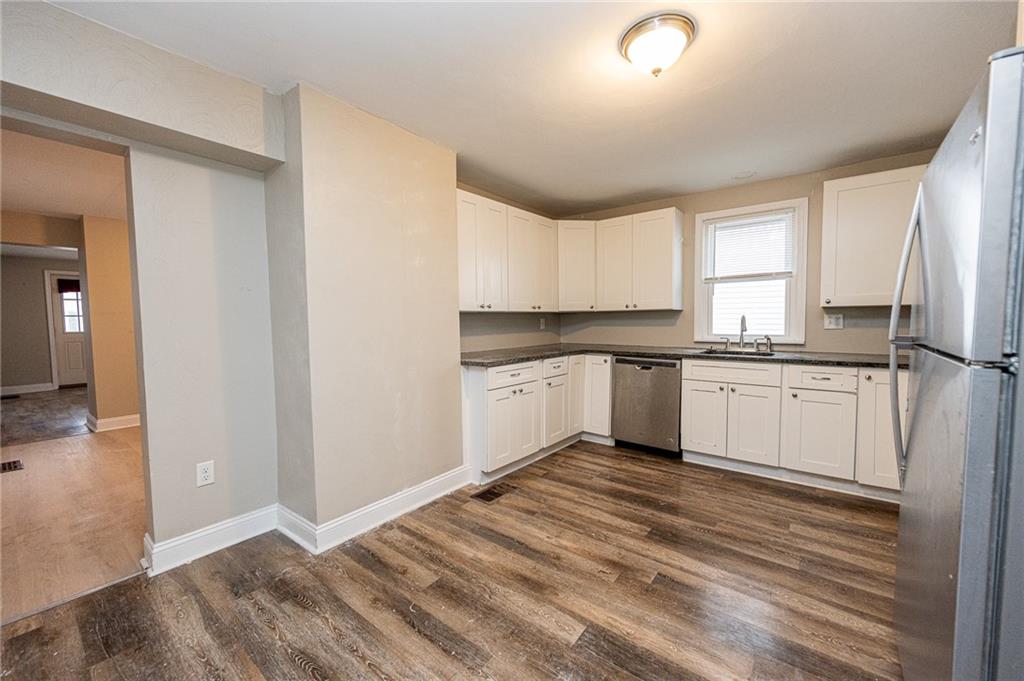 105 Washington Street Mount Pleasant, PA 15666 - Photo 9 of 29 a kitchen with a sink cabinets stainless steel appliances and a window