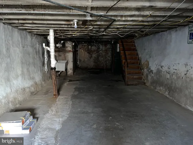 a city street lined with parked cars and buildings