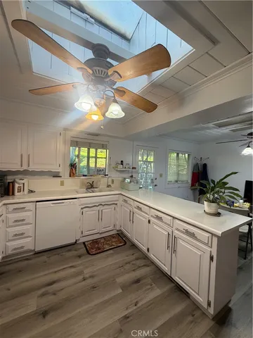 a kitchen with sink cabinets and wooden floor