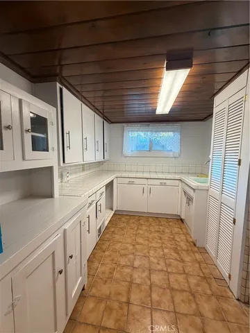 a large kitchen with white cabinets