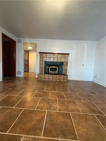 a view of an empty room with a fireplace