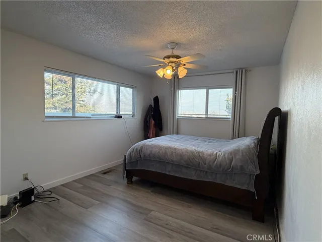 a bedroom with a bed lamps and window