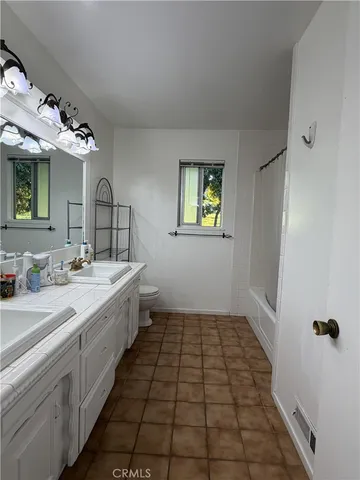 a large bathroom with a double vanity sink and a mirror