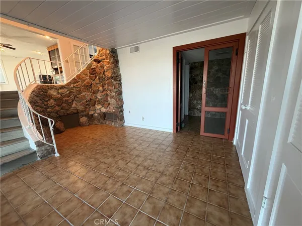 a view of an empty room with stairs