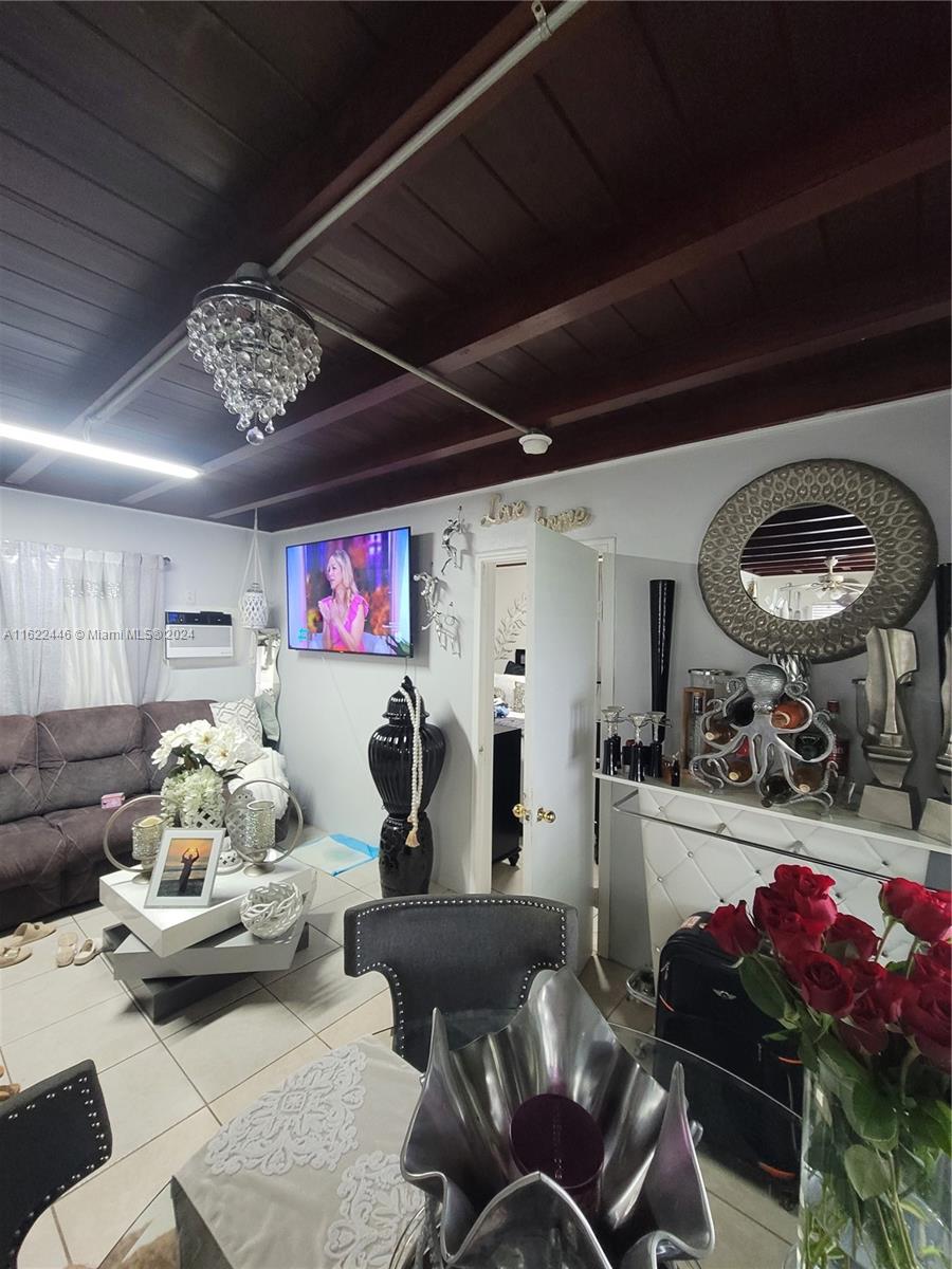 5719 Johnson Street, Unit 15 Hollywood, FL 33021 - Photo 17 of 29 a living room with furniture and a chandelier