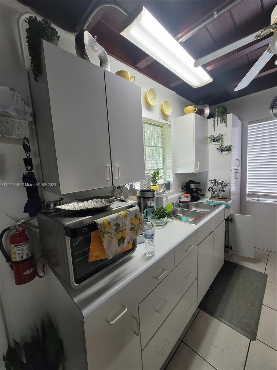 5719 Johnson Street, Unit 15 Hollywood, FL 33021 - Photo 18 of 29 a kitchen with a stove and a sink