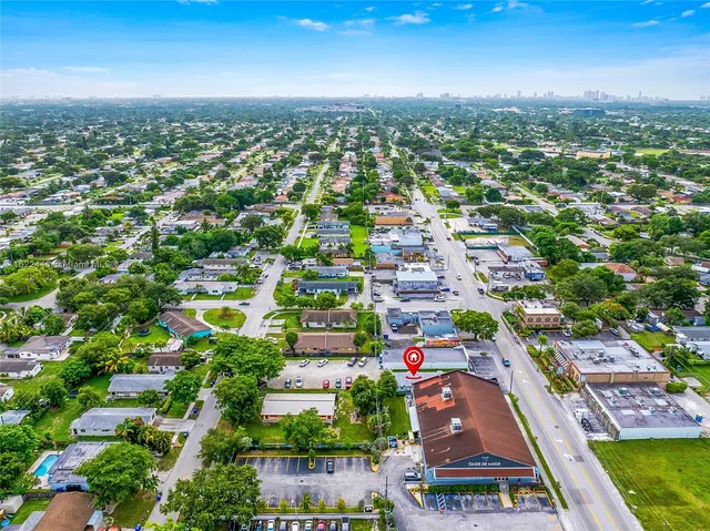 an aerial view of residential houses with outdoor space and street view