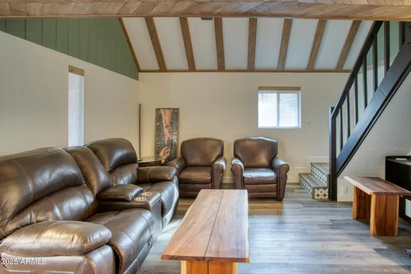 a living room with furniture a fireplace and wooden floor