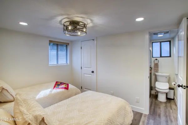 a bedroom with a bed and a chandelier