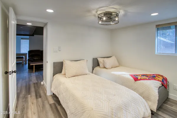 a bedroom with a bed and a lamp on table