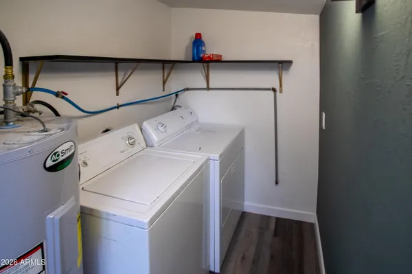 a view of a house with a yard and large tree