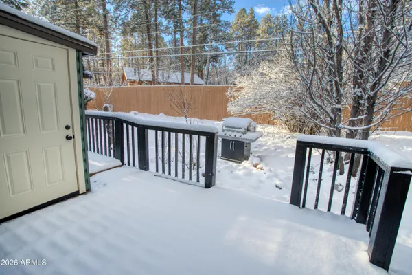 a front view of a house with a yard covered in snow