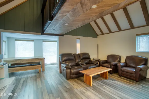 a living room with furniture and wooden floors