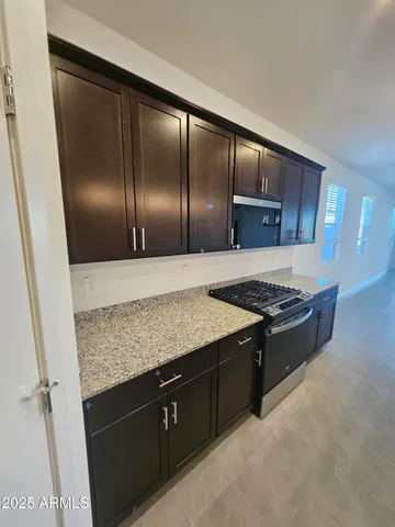 a view of empty room with a window and a fireplace