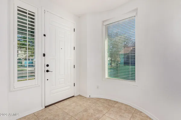 a large kitchen with kitchen island a large counter top stainless steel appliances and cabinets