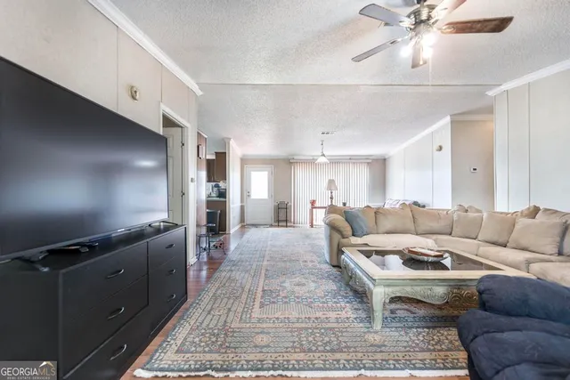a living room with furniture and wooden floor