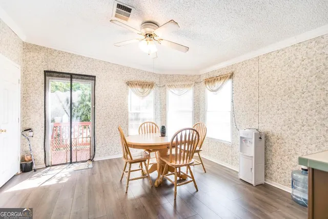 a view of a dining room with furniture window and wooden floor