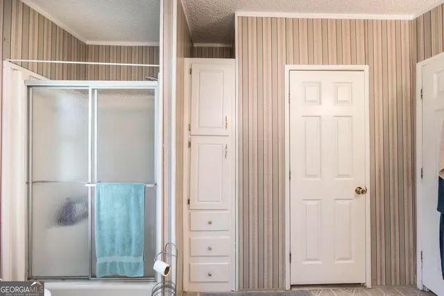 a view of a workspace with furniture and a rug