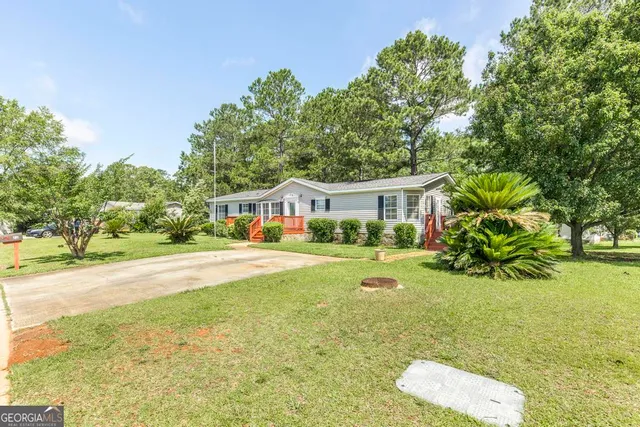 a front view of house with yard and green space