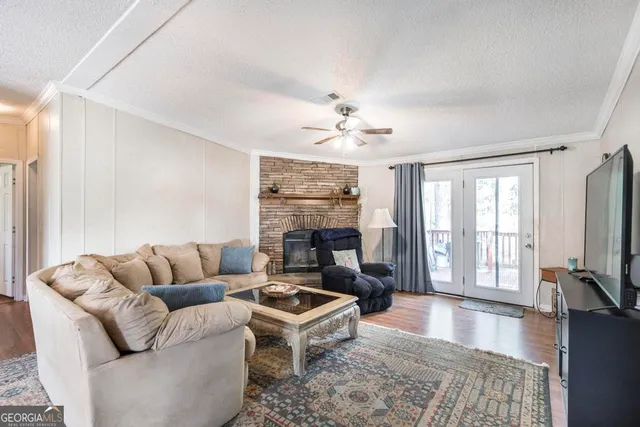 a living room with furniture flat screen tv and a fireplace