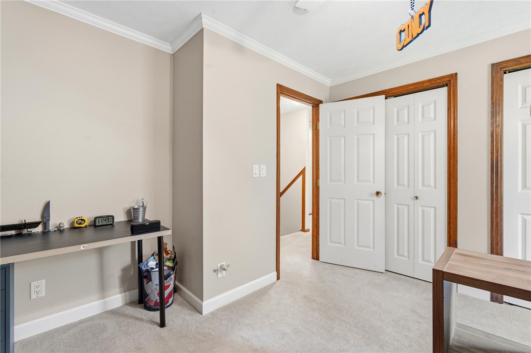 10168 Atchison Road Dayton, OH 45458 - Photo 38 of 44 This cozy room offers carpeted flooring and crown molding, creating a comfortable and inviting atmosphere.