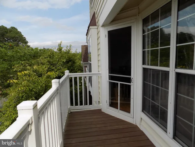 a balcony with wooden floor and fence
