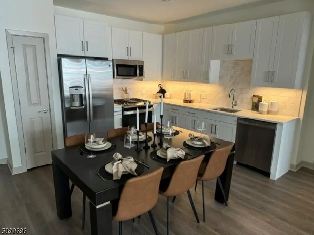 a kitchen with a dining table and chairs
