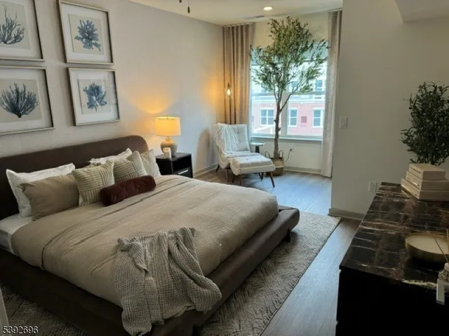 a spacious bedroom with a bed and wooden floor