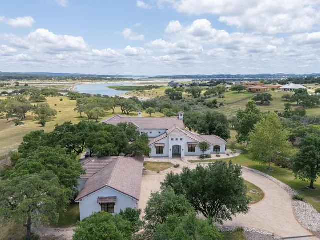 an aerial view of residential houses with outdoor space and ocean view
