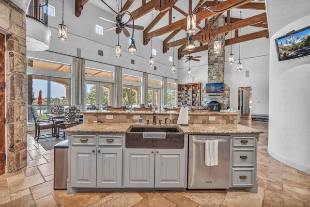 a kitchen with stainless steel appliances granite countertop a stove and cabinets