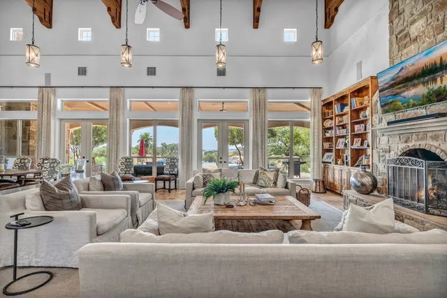 a living room with furniture and large windows