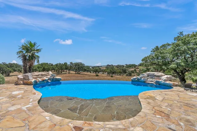 a view of a swimming pool and lounge chair