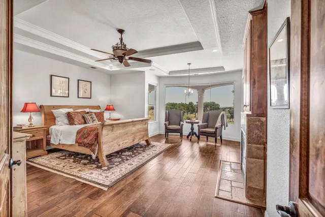 a bedroom with furniture and a chandelier