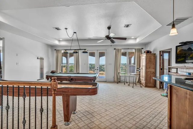 a living room with furniture a flat screen tv and kitchen view