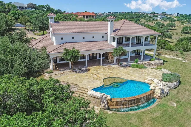 an aerial view of house with yard swimming pool and outdoor seating