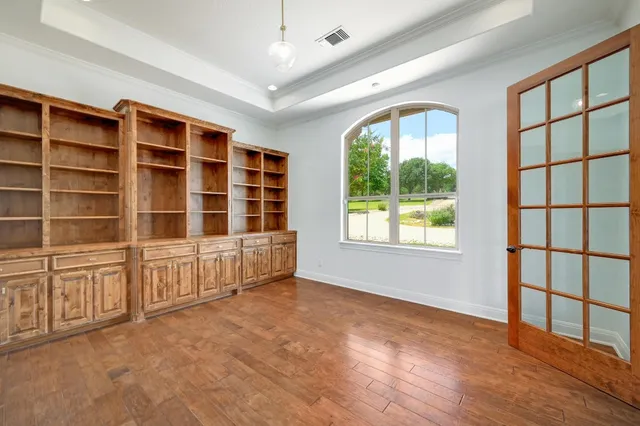 a view of an empty room with a window and balcony