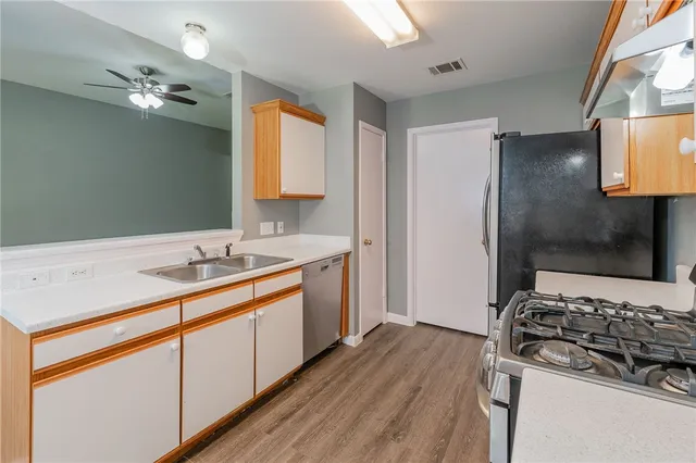 a kitchen with a sink stove and refrigerator