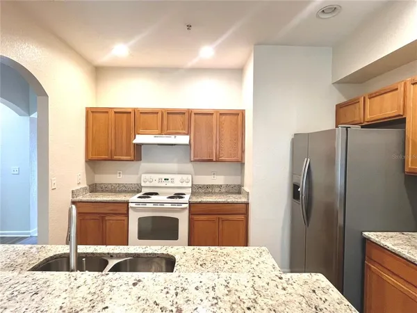 a kitchen with a sink appliances and cabinets
