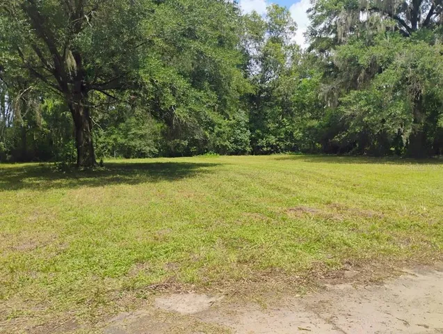 a view of a yard with a table and chair
