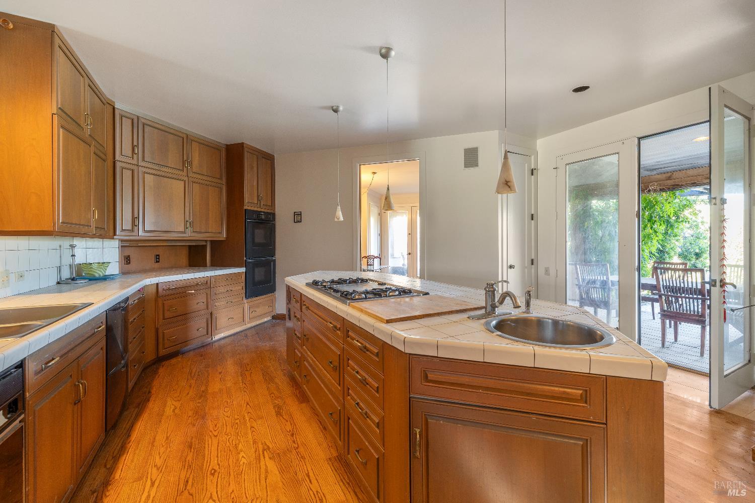 3295 Warm Springs Road Glen Ellen, CA 95442 - Photo 19 of 37 a kitchen with kitchen island granite countertop a sink stove and wooden cabinets