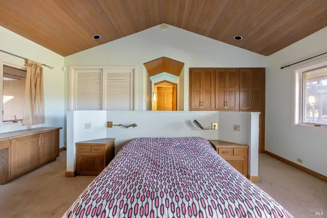 a spacious bedroom with a bed and a fireplace