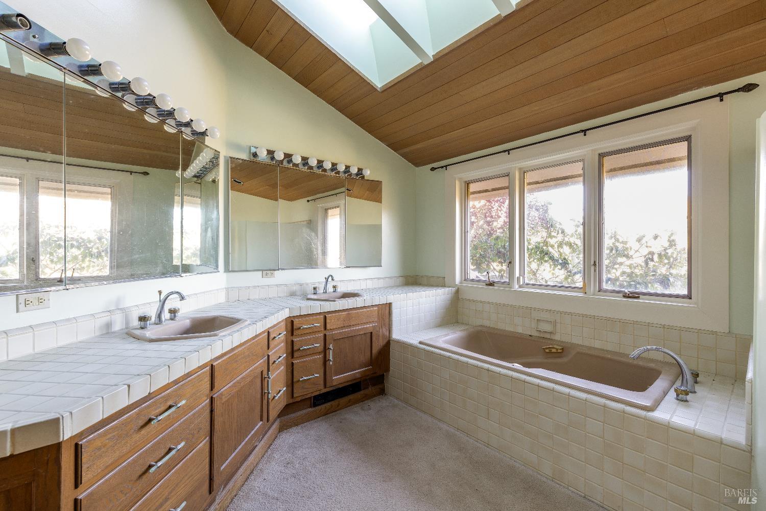 3295 Warm Springs Road Glen Ellen, CA 95442 - Photo 26 of 37 a bathroom with a granite countertop tub sink and mirror
