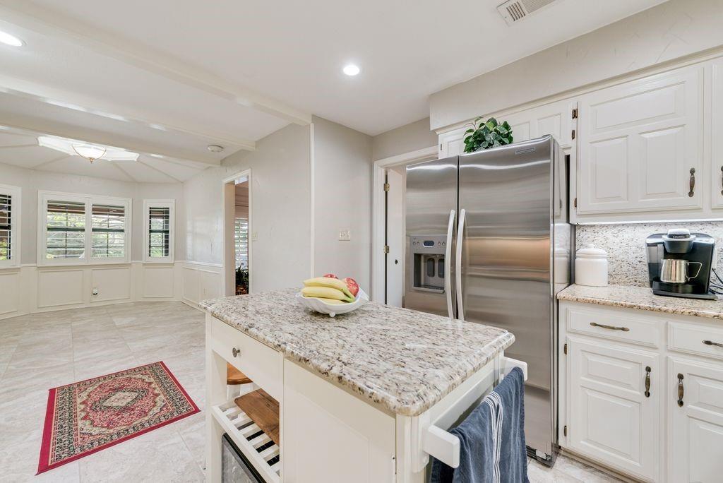 802 Riva Ridge Wylie, TX 75098 - Photo 12 of 39 a kitchen with kitchen island a counter space and refrigerator