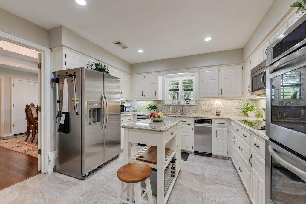 802 Riva Ridge Wylie, TX 75098 - Photo 14 of 39 a kitchen with stainless steel appliances a refrigerator sink and stove