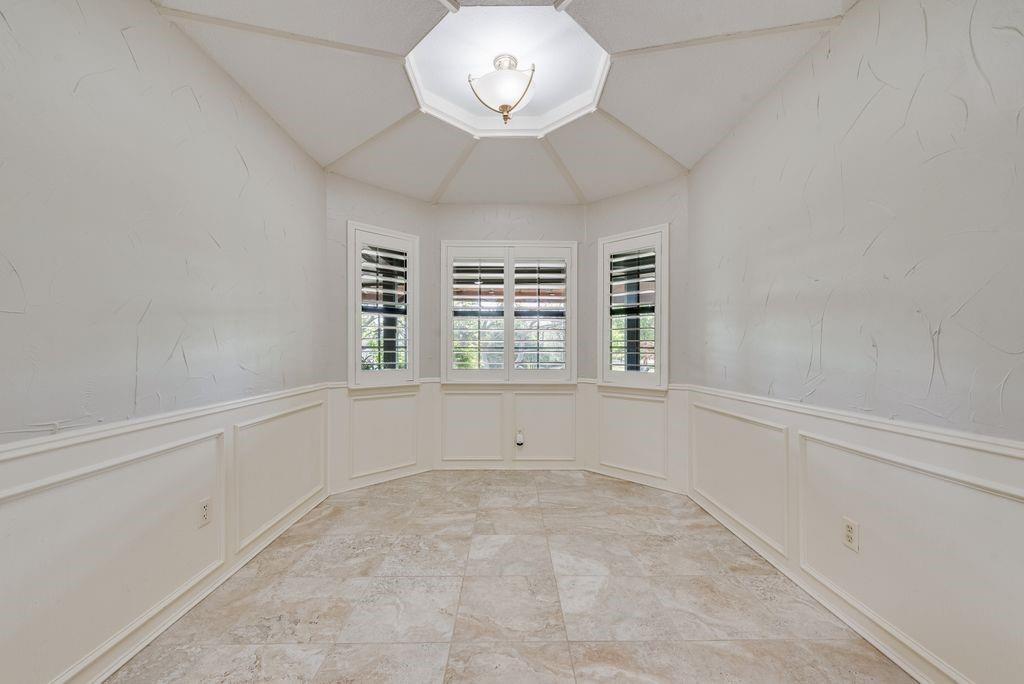 802 Riva Ridge Wylie, TX 75098 - Photo 16 of 39 an empty room with windows and chandelier fan
