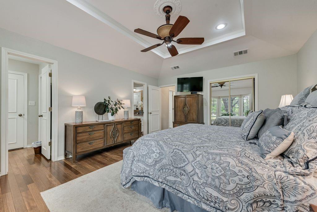 802 Riva Ridge Wylie, TX 75098 - Photo 20 of 39 a bedroom with a bed dresser and wooden floor